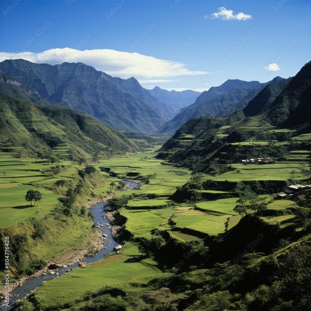 Lush green valley surrounded by towering mountains