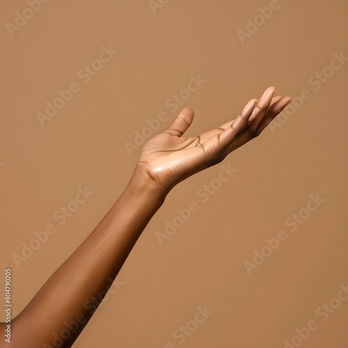 Single open hand with palm up on a smooth beige backdrop