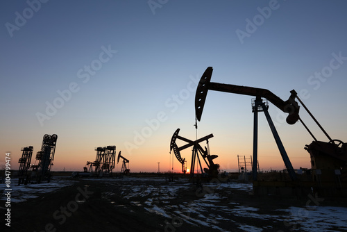 In the evening, oil pumps are running, Silhouette of beam pumping unit