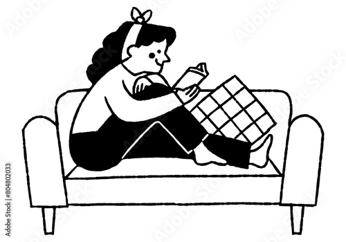 Woman sitting on a sofa reading a book_2