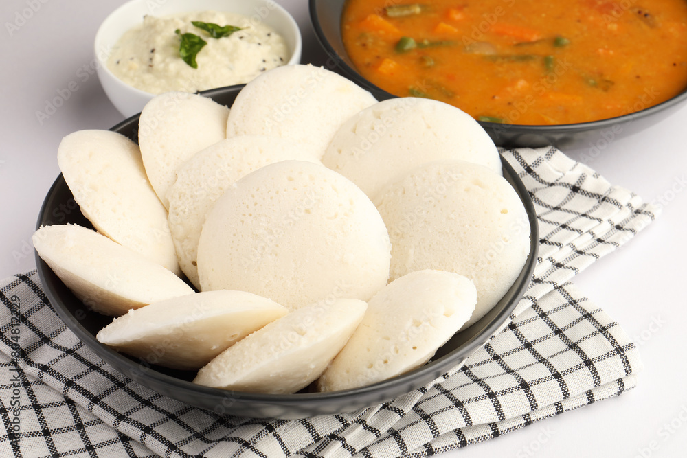 Idly sambar or Idli with Sambhar and green, red chutney. Popular South indian breakfast Idly sambar or Idli with Sambhar and green, red chutney. Popular South indian breakfast