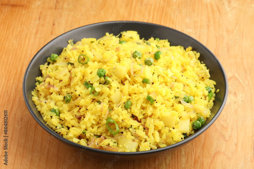 Indian Breakfast Dish Poha Also Know as Pohe or Aalu poha made up of Beaten Rice or Flattened Rice. The rice flakes are lightly fried in oil with mustard, turmeric, onion, curry leaves Indian Breakfast Dish Poha Also Know as Pohe or Aalu poha made up of Beaten Rice or Flattened Rice. The rice flakes are lightly fried in oil with mustard, turmeric, onion, curry leaves