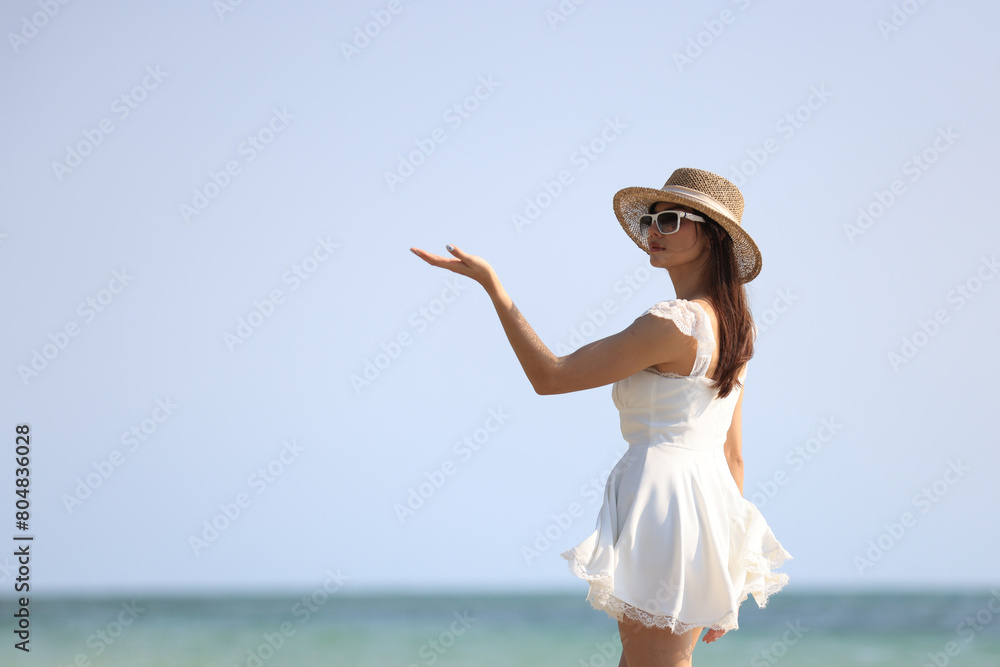 Joyful beautiful woman with white dress walk relax on tropical beach , summer vacation and travel Joyful beautiful woman with white dress walk relax on tropical beach , summer vacation and travel