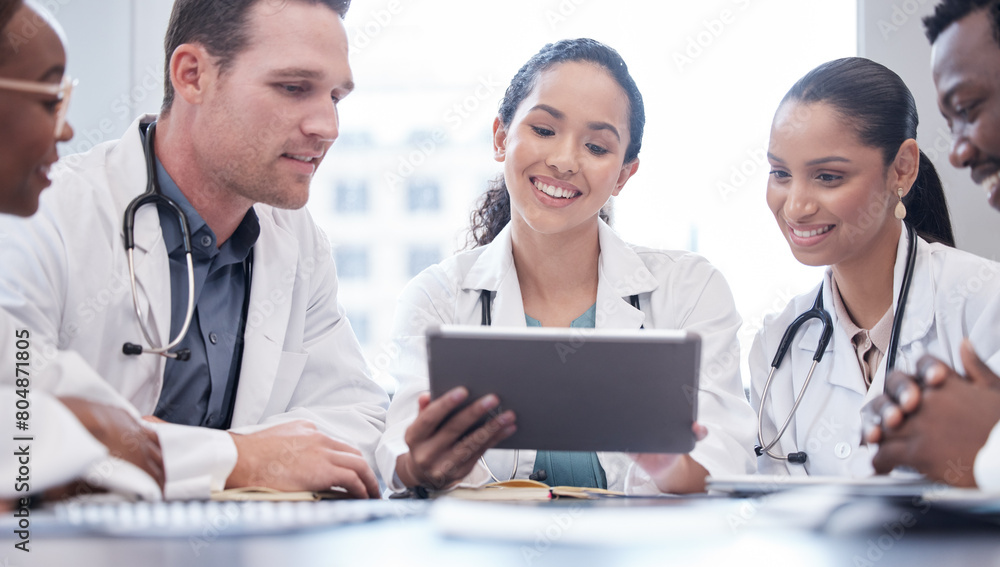 Smile, doctors and team on tablet for planning research, healthcare or people in discussion in hospital. Tech, happy and medical professional group in meeting for collaboration, wellness or diversity Smile, doctors and team on tablet for planning research, healthcare or people in discussion in hospital. Tech, happy and medical professional group in meeting for collaboration, wellness or diversity