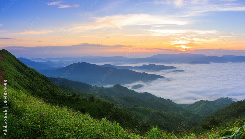 Naklejka premium green mountain with fog and sunrise twilight sky at background
