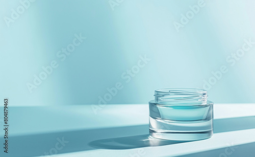 Hydration Elixir: Clear Blue Jar of Moisturizing Cream againts Blue Background