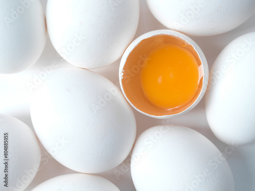 white chicken eggs on a white background, free range orange yolk
