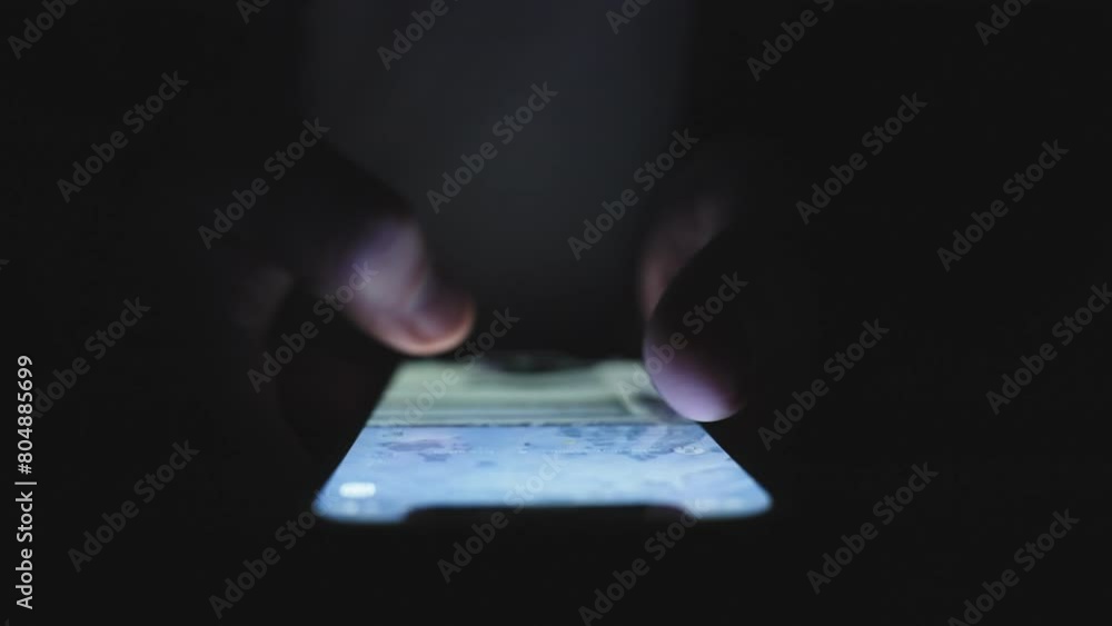 Male fingers touching the screen of the phone in the dark. Slow motion Male fingers touching the screen of the phone in the dark. Slow motion