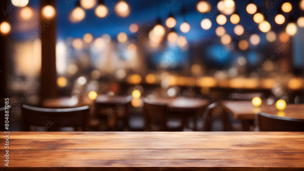 Image of empty wooden table in front of abstract blurred restaurant lights background