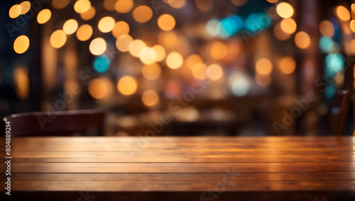 Image of empty wooden table in front of abstract blurred bokeh lights background