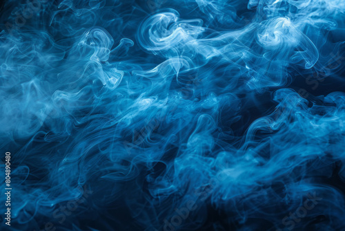 Blue abstract smoke curls and flows on a dark background