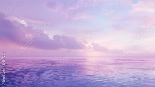 Tranquil seascape under a soft pink and purple sky, reflecting the calm waters at sunset. © Ritthichai