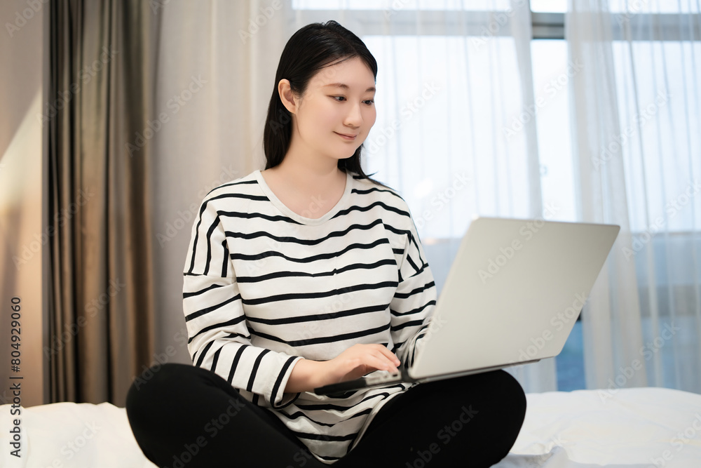 Young Woman Working Remotely from a Cozy Room Young Woman Working Remotely from a Cozy Room