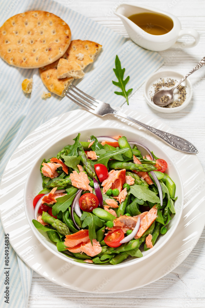 smoked salmon salad with spring veggies in bowl smoked salmon salad with spring veggies in bowl