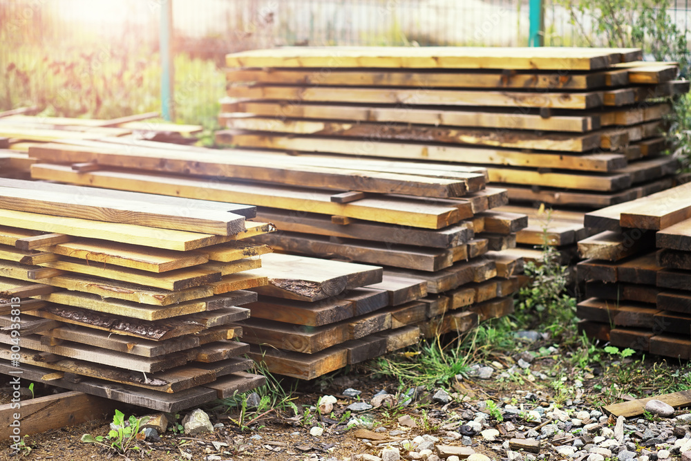 Stack of fresh pine boards in a sawmill warehouse. Harvesting, sale of lumber for construction