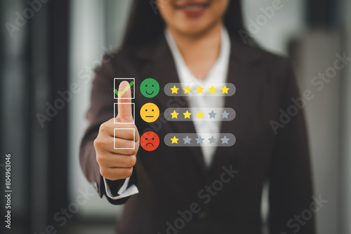 Professional woman in suit touching virtual five-star rating system, indicating a positive review. High satisfaction with a service or product concept