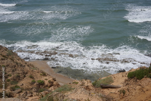 Mediterranean sea in spring.  Deserted shorekurkar sandstone cliff nature reserve, high above the Mediterranean sea coastline between Herzliya and Netanya towns, Israel. photo