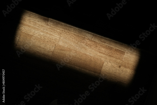 Wooden background in a morning light and shadow from a window frame.