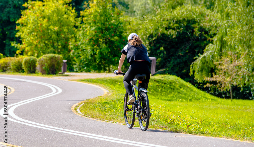 Cyclist ride on the bike path in the city Park