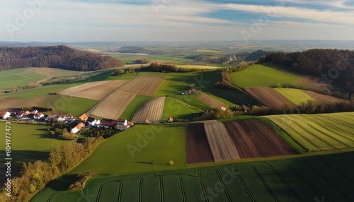 Aerial view of vivid green farmland fields in a charming european countryside village