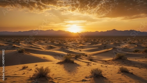 Sunset with clouds over a serene desert landscape