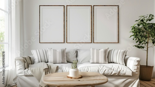 render of three vertical blank frames in a mockup cozy living room  a white sofa with striped pillows and a wooden white table near a window with natural light  white walls
