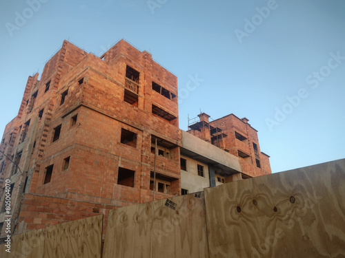 Building under construction in Brazil, view over the blue sky. Housing complex under construction.