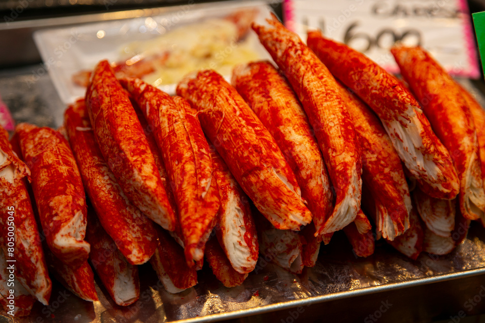 King crab legs cooked on a barbecue in the city of Osaka in Japan. King crab legs cooked on a barbecue in the city of Osaka in Japan.