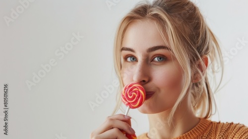 Woman eating a lollipop with a thoughtful face on a white background © Сергей Безрученко