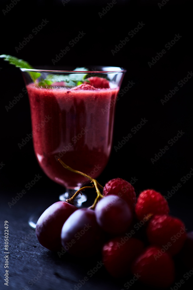 Fresh smoothie in a glass. Dark background. Close up. Fresh smoothie in a glass. Dark background. Close up.