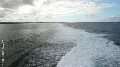 Waves that break on the reef on the coast of the island of Mauritius and slowly run out towards the island.