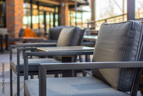 A row of chairs placed neatly on top of a sidewalk in a modern outdoor seating area