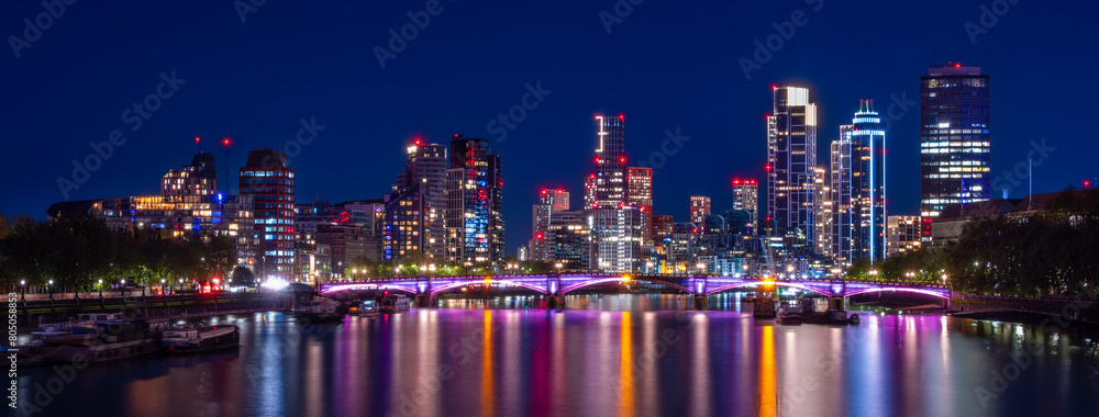Lambeth Bridge, river Thames and cityscape of London with skyscrapers in blue hour