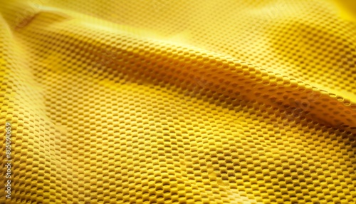 A detailed texture of a yellow soccer jersey, representing the sportive spirit and national colors of Brazil, suitable for sports fashion or team-related displays