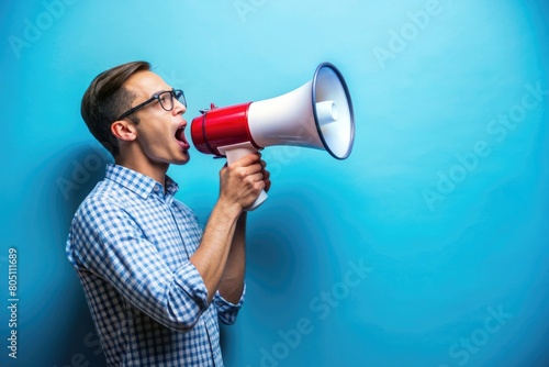 Person holding a megaphone with blue background © Musarrof