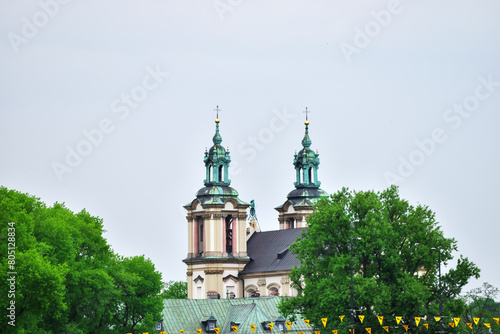 Summer view of Wawel Royal Castle complex in Krakow, Poland. It is the most historically and culturally important site in Poland. Trees on a foreground