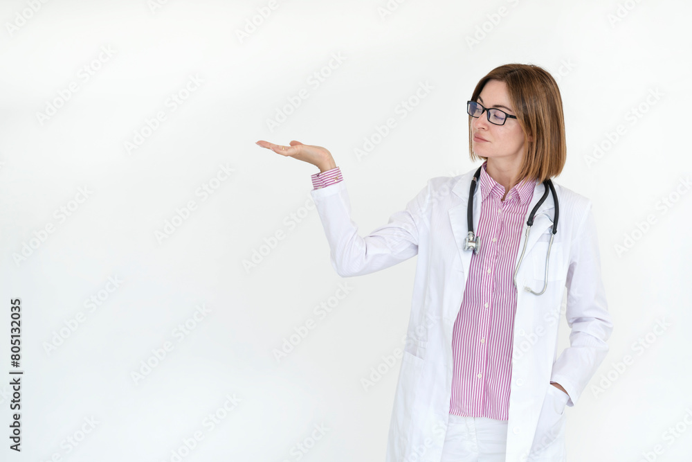 Female doctor standing and pointing on free space isolated on white background Female doctor standing and pointing on free space isolated on white background