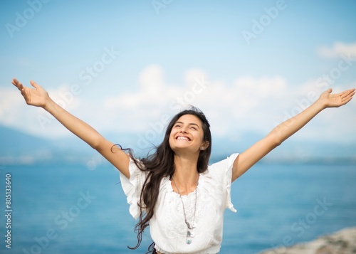 A beautiful woman standing with open arms and enjoying with copy space for your advertisement