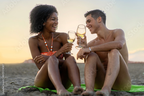 Interracial Couple Toasting on Beach - Romantic Sunset Celebration (ID: 805139087)