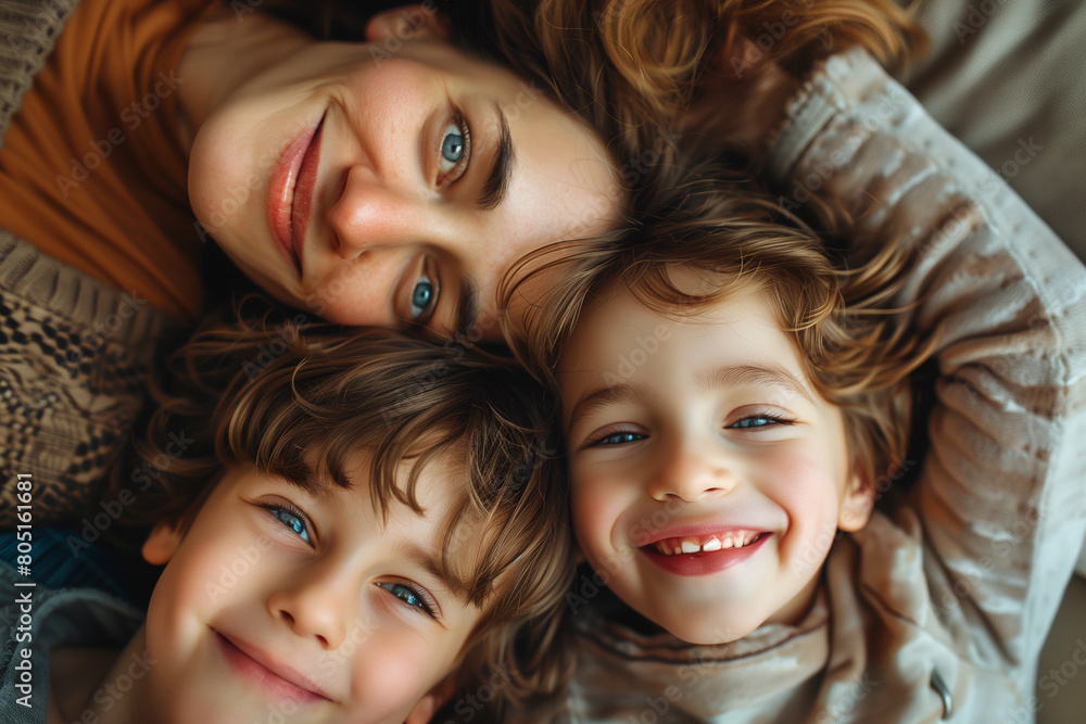Warm and Joyful Family Moment Captured Indoors: A Smiling Mother Embraces Her Two Happy Children, Reflecting the Love, Comfort, and Cheerful Bonding in a Cozy, Candid Lifestyle Setting