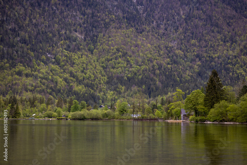 A magical morning atmosphere at a lake that is surrounded by alpine mountains.
