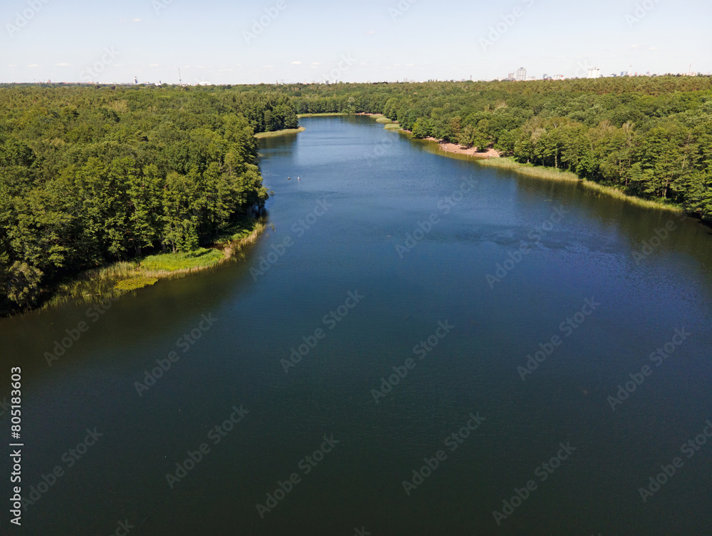 Aerial landscape of lake and Jagdschloss Grunewald in forest on a sunny summer day in Berlin