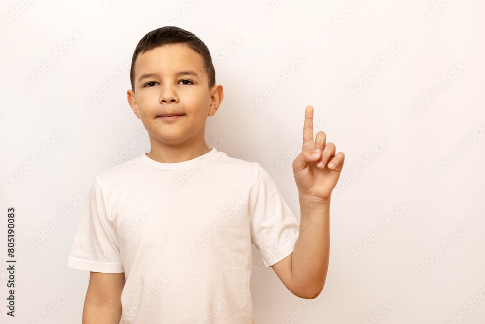 The boy raised his index finger, attracting attention. The boy raised his index finger, attracting attention.