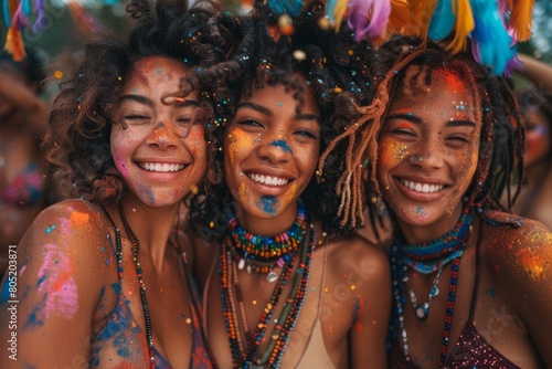 Smiling friends enjoying a festival, splattered with colorful glitter and wearing beads