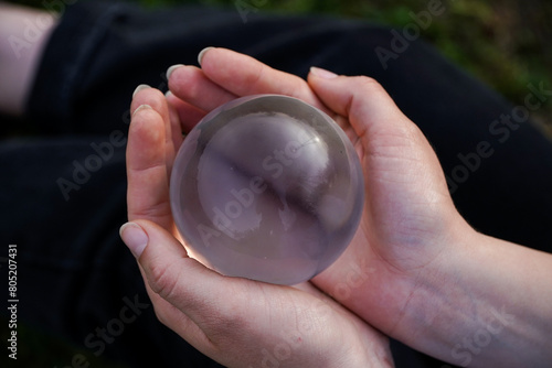 Crystal Sphere. Crystal Sphere, used for meditation, clairvoyance, health, luck and abundance! Hands covering the crystal sphere. Day photo. Crystal sphere in various angles.Various backgrounds. 