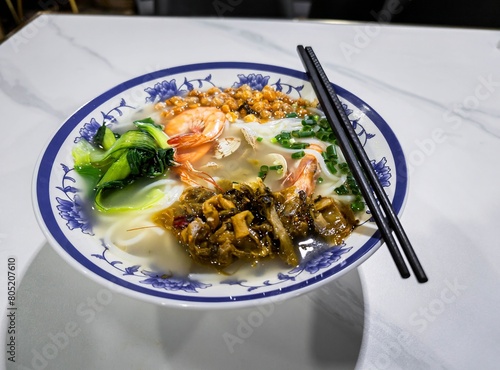 A bowl of noodles and seafood noodles from a regular Chinese restaurant