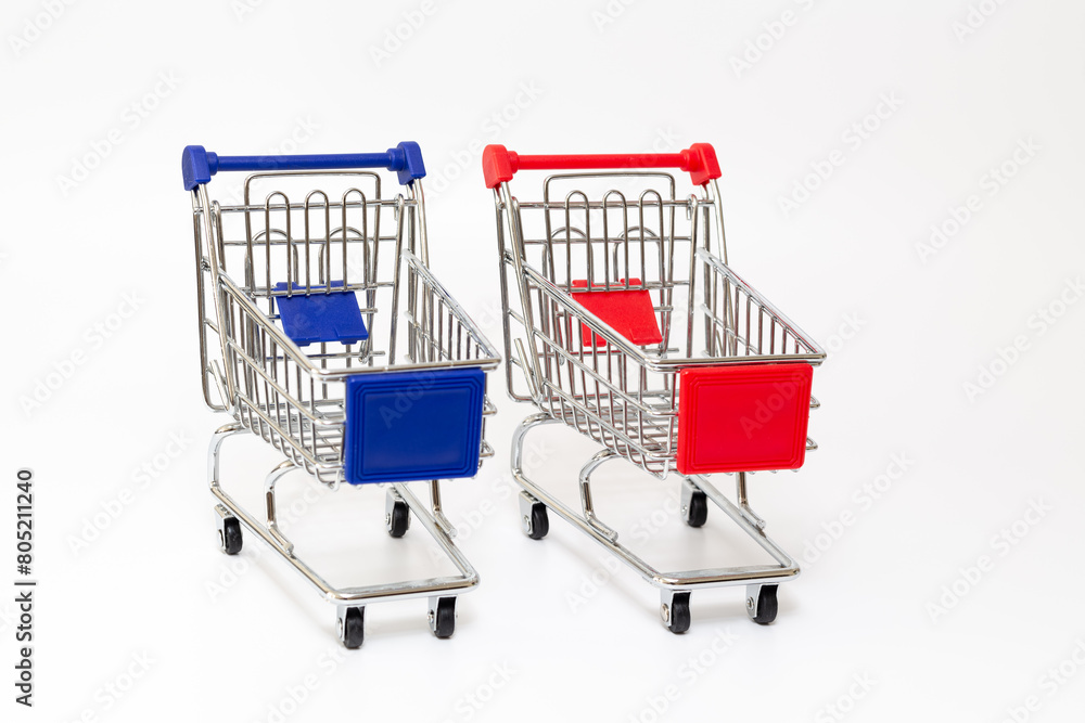 Toy shopping carts. Toy shopping trolleys on white background. Toy shopping carts. Toy shopping trolleys on white background.