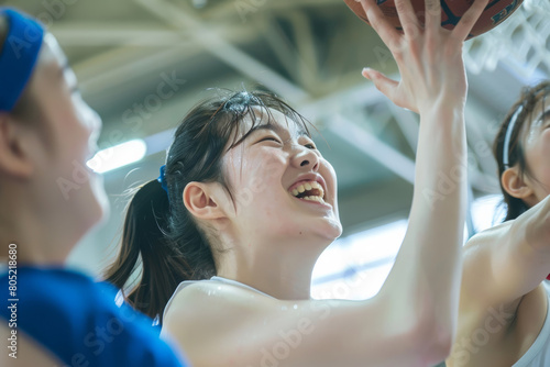 A group of female women are enjoying playing basketball happily and restlessly together on the basketball court. photo