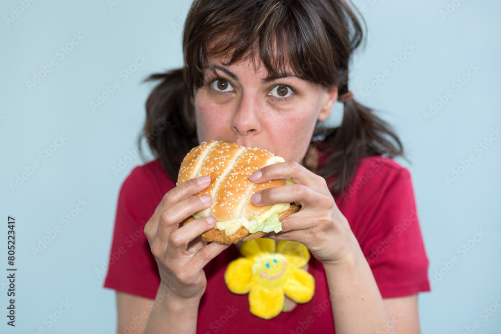 Woman Eating Chicken Burger in Switzerland. Woman Eating Chicken Burger in Switzerland.