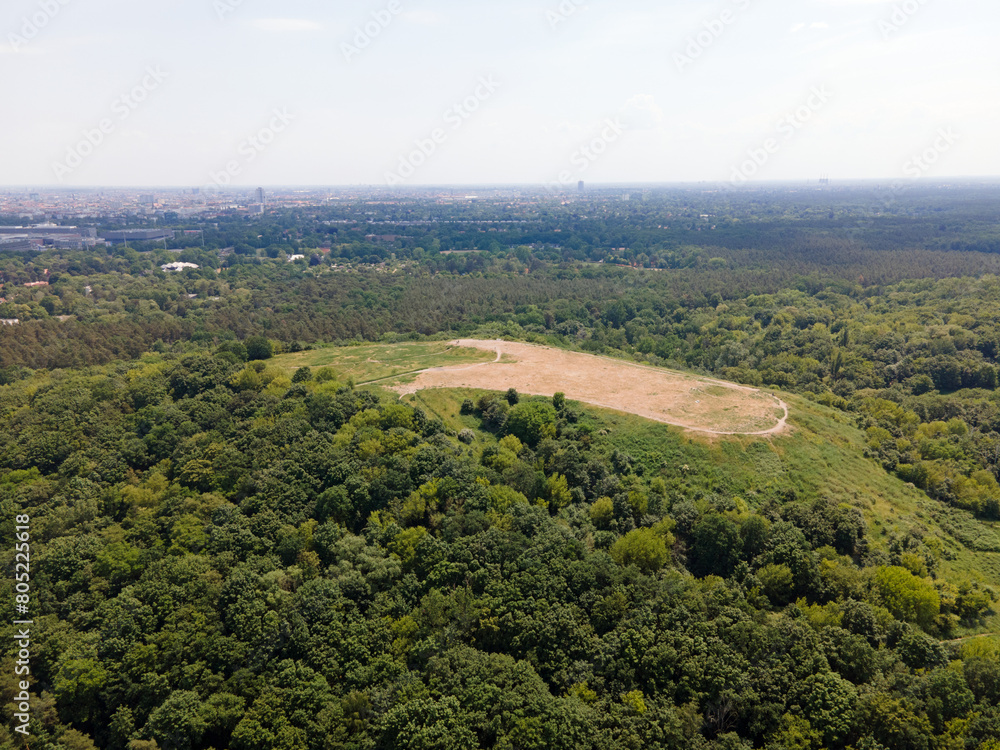 Naklejka premium Aerial landscape of Drachenberg trash mountain in Grunewald forest on a sunny day in Berlin
